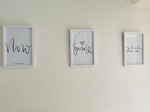 three pictures on a wall with writing on them at das Höfchen Stadecken in Stadecken-Elsheim