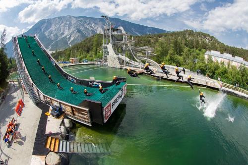 a group of people on a bridge in the water at Living Apart Haslwanter Ferienwohnung in Haiming
