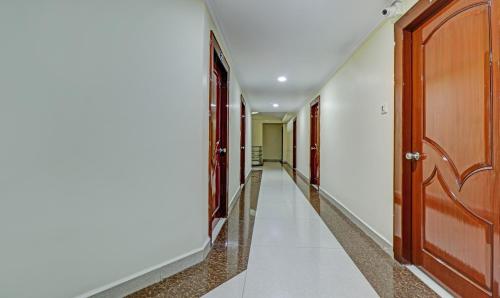a corridor in a house with wooden doors at Eesha Elite in Visakhapatnam