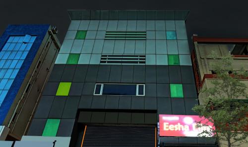 a tall building with a sign on the side of it at Eesha Elite in Visakhapatnam