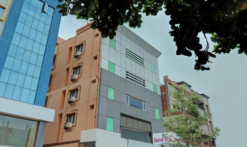 an apartment building with a facade of glass at Eesha Elite in Visakhapatnam