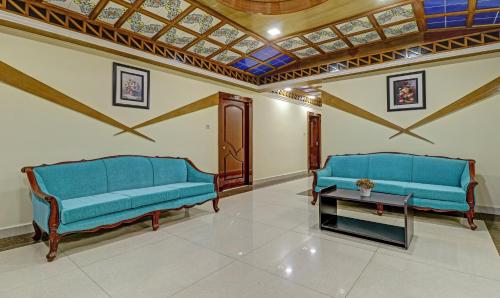 two blue benches in a room with a ceiling at Eesha Elite in Visakhapatnam