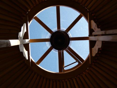 a view from the bottom of a circular window at Romantic yurt in Apuseni mountains in Grohoţele