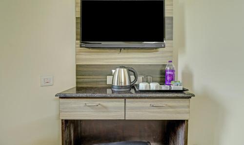 a flat screen tv sitting on top of a dresser at Eesha Elite in Visakhapatnam