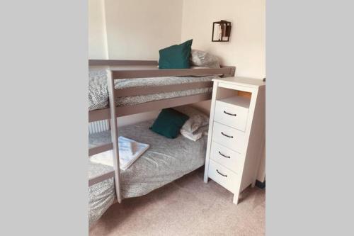 a bedroom with two bunk beds and a desk at Traditional 2-bedroom Cornish cottage in Newlyn in Newlyn