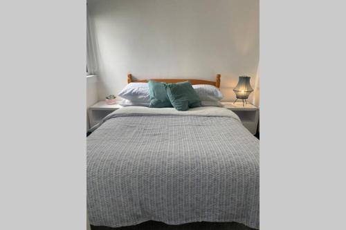 a bedroom with a bed and two night stands at Traditional 2-bedroom Cornish cottage in Newlyn in Newlyn