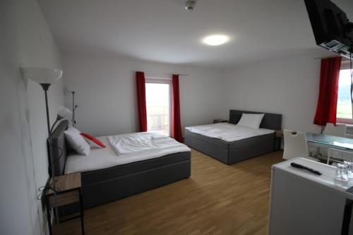 a bedroom with a bed and a couch and a table at Weinlandzimmer in Hengsberg