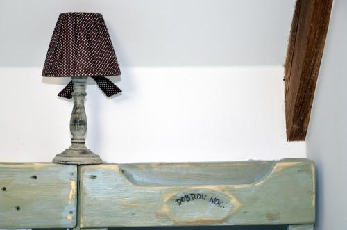 a lamp sitting on top of a wooden bed at Apartmány Kojákovice - Třeboň in Jílovice