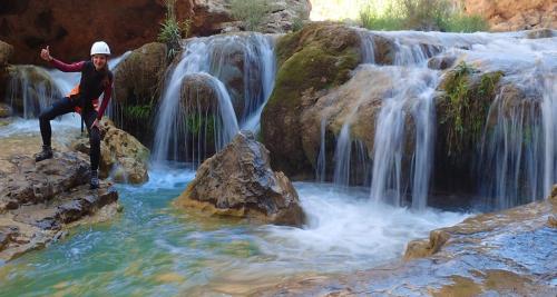 a person standing in front of a waterfall at EL RECOVECO DE MIRA in Mira