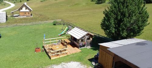 an aerial view of a house with a wooden fence at Ferienwohnungen Almsonne in Thomatal