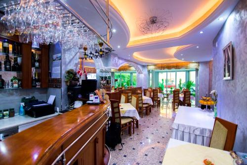 a restaurant with a bar and some tables and chairs at Villa Dislievski in Ohrid