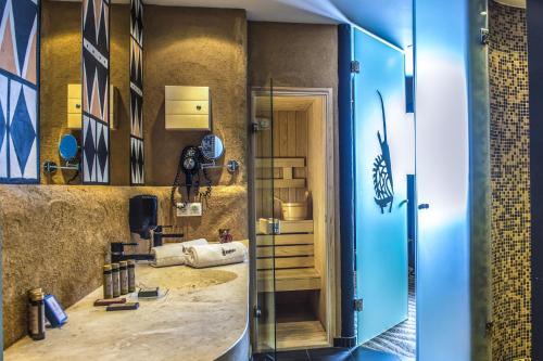 a bathroom with a sink and a mirror at Bambara Hotel in Felsőtárkány