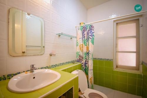 a bathroom with a sink and a toilet and a mirror at 300m from beach - Luxury Mediterranean Holiday House - Pets Welcome in Bang Sare