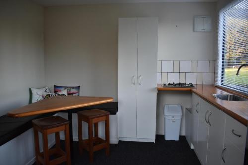 a small kitchen with a counter and a sink at Matauri Bay Holiday Park in Matauri Bay
