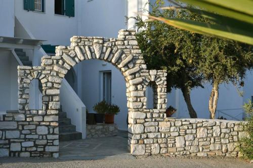 um arco numa parede de pedra ao lado de um edifício em Sandaya Living - M Apartment em Naousa