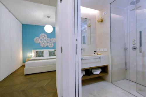 a bathroom with a sink and a shower and a bed at Luxury Domus Apartment 2 in Rome