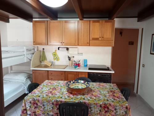 a kitchen with a table with a table cloth on it at Casa Sole e Mare indipendente a Triscina in Triscina