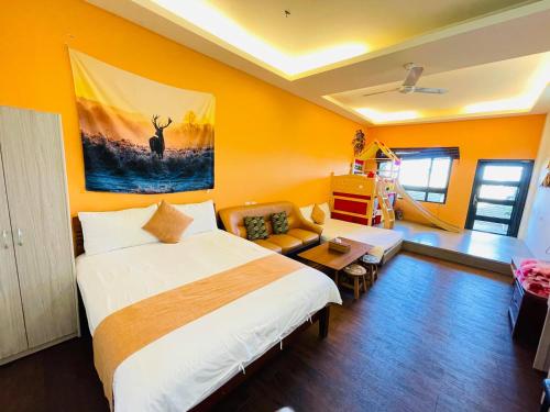 a bedroom with a large bed and a living room at E-Phone Homestay in Ji'an