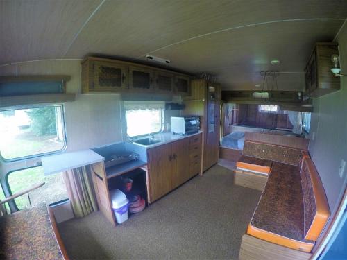 an interior view of an rv with a kitchen at Matauri Bay Holiday Park in Matauri Bay