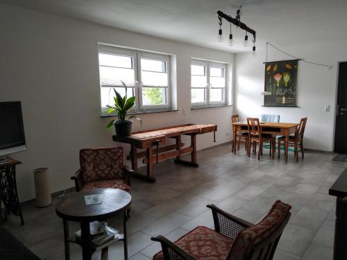 a living room with a table and chairs at Villa Hinterland in Biedenkopf