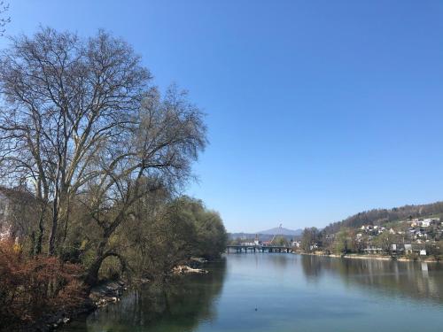 a view of a river with trees and a bridge at Gästezimmer Erlinsbach bei Aarau, zwischen Aare und Jura in Niedererlinsbach