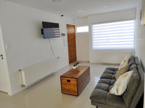 a living room with a couch and a coffee table at Casa nueva, excelente ubicación in Punta Arenas