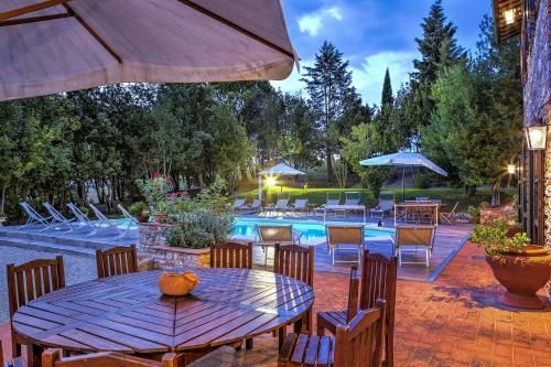 a patio with a table and chairs and a pool at L’Aurora in Todi