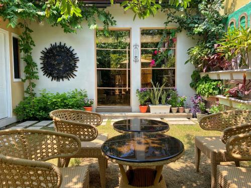 a patio with tables and chairs in front of a house at The Art Hotel by VIA VARANASI in Varanasi