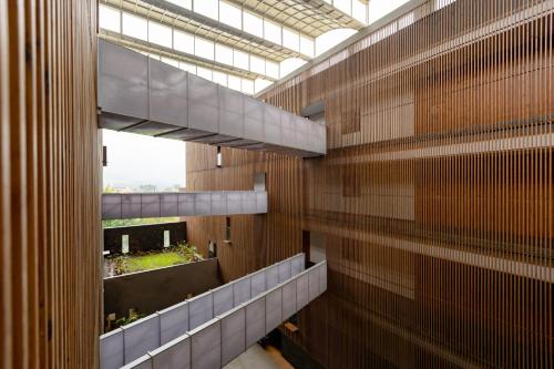 a hallway of a building with wooden walls and windows at Radisson Resort and Spa Lonavala in Lonavala