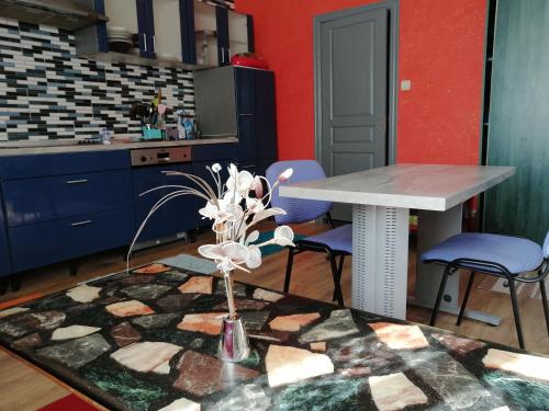a kitchen with a table and purple chairs and a table at Freedom in Uzhhorod