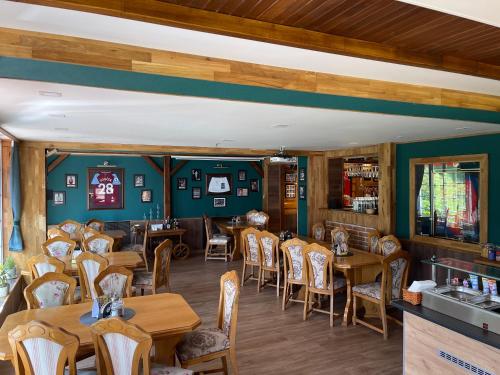 a dining room with wooden tables and chairs at Penzion Zákoutí in Pec pod Sněžkou