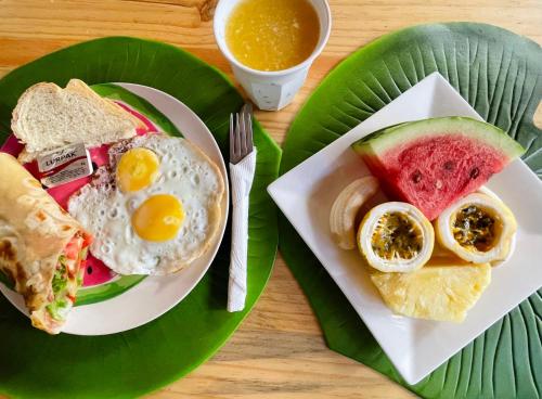 een bord ontbijtproducten met eieren en fruit bij Max Hotel Nungwi in Nungwi