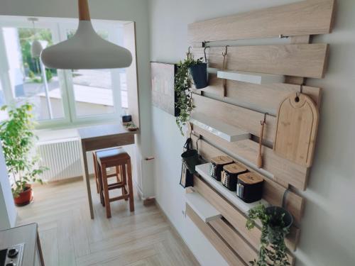 a room with a wall of drawers and plants at Apartman Lena in Tuzla
