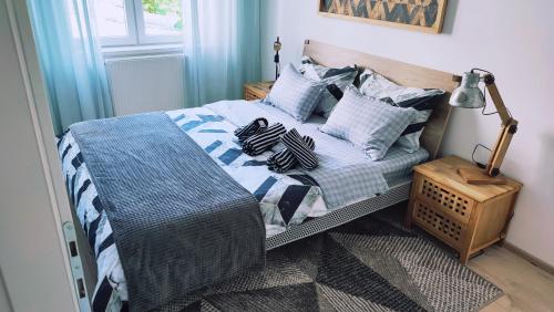 a bed with pillows on it in a bedroom at Apartman Lena in Tuzla