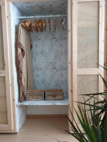 a dressing room with a shelf and a curtain at Aretousa Deluxe Downtown Apartment in Skala