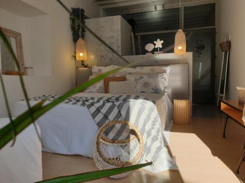 a bedroom with a white bed with a basket on it at Aretousa Deluxe Downtown Apartment in Skala