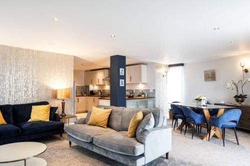 a living room with a couch and a table at Beautiful 3 bedroom apartment by the Sea in Newquay
