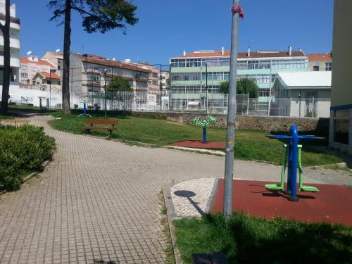 a park with a playground and a bench and buildings at Isabel Dream II, 300m from the train in Algueirão - Mem Martins