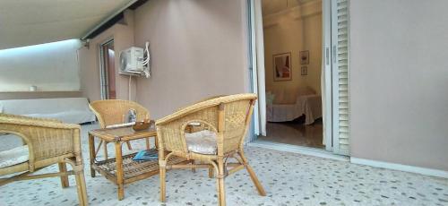 a room with chairs and a table and a bed at Experience the sweetest nest at Marina Zea in Piraeus