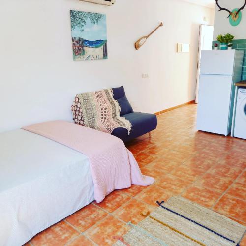 a living room with a couch and a refrigerator at Agua Amarga Design in Agua Amarga