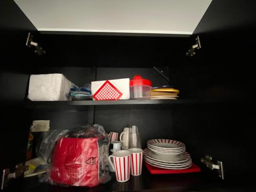 a shelf with plates and cups and dishes in a refrigerator at Tropical apartment in Cancún