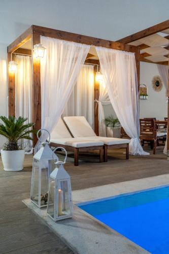 a bedroom with a bed and a swimming pool at Villa Elisabeth View in Plataniás