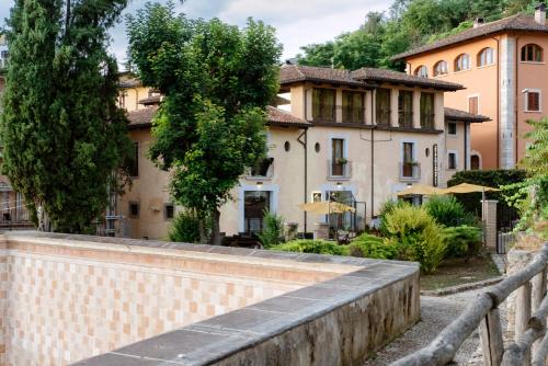 a brick wall in front of a house at Hotel 99 Cannelle in LʼAquila