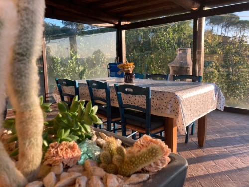 a table and chairs on a porch with a table and a view at CASA LORY Poggio Murella in Poggio Murella