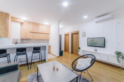 a kitchen and living room with a couch and a table at LUST PREMIUM Apartments in Kragujevac