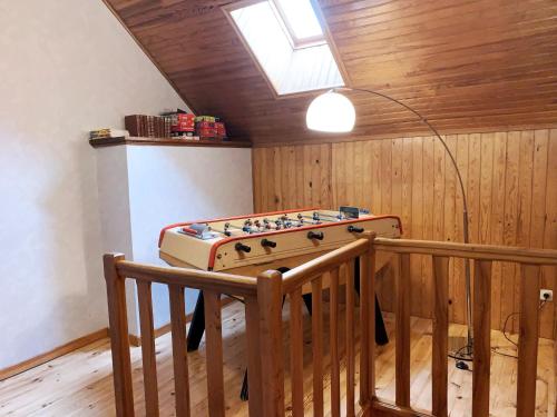a room with a foosball table with a lamp in it at L'Orée des Pignes in Nojaret