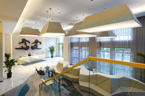 a lobby with a person on a snowboard on the wall at Modena By Fraser New District Wuxi in Wuxi