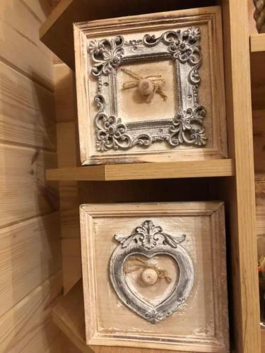 a couple of wooden boxes sitting on a shelf at Ragaciema Skadiņi in Ragaciems