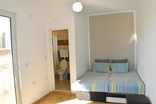 a bedroom with a bed and a mirror at Apartments Murati in Ulcinj