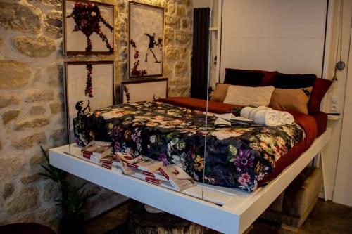 a display of a bed in a room with a table at Tiny Gallery Paris Gare Montparnasse in Paris